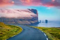 Magnificent summer view of popular tourist attraction - Risin og Kellingin cliffs with asphalt road. Fantastic sunrise of Eysturoy