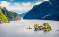 Magnificent summer view with small island with typical Norwegian building on Lovrafjorden flord, North sea. Colorful morning view