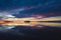 Magnificent sunrise over lake Malaren in Sweden, Calm water reflecting sky with dramatic clouds illuminated pink by sun