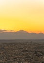 Golden hour sky overlooking a cityscape of Tokyo with Fuji mountain on the horizon. Royalty Free Stock Photo