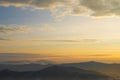 Magnificent sunset in the mountains landscape. Dramatic sky. Mountain forest landscape under evening sky with clouds in sunlight. Royalty Free Stock Photo