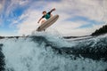 magnificent view of man flying in the air on wakesurf over splashing wave