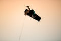 athletic man doing flip trick in the air on wakeboard against the sky Royalty Free Stock Photo