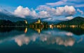 Magnificent view of Bled lake and illuminated pilgrimage church on island at twilight reflected in water, Slovenia Royalty Free Stock Photo