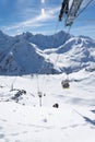 Magnificent view of the snow-white towering mighty mountains Elbrus and the cable ways, ski resort, Kabardinobalkaria, Russia