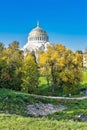 Russia, Kronstadt, September 2020. The dome of an Orthodox cathedral among the yellow foliage of the old park.