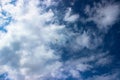 Beautiful colorful kite flying in a blue cloudy sky Royalty Free Stock Photo