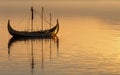 A magnificent Viking longship sails gracefully across the still waters, exuding an aura of ancient seafaring tradition