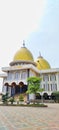 A magnificent white mosque building with golden domes