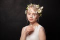 Magnificent young beautiful woman with white flower and butterfly on black background Royalty Free Stock Photo