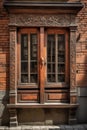 Magnificently decorated wooden window shutters with intricate knot designs and historical scenes ornate