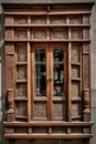 Magnificently decorated wooden window shutters with intricate knot designs and historical scenes ornate