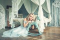 Magnificient woman in blue tulle dress in luxurious vintage interior portrait