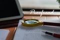 Magnifier on blurred proofreading paper with proofread text Royalty Free Stock Photo
