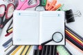 Magnifier, day planner and office supplies on white background .photo with copy space Royalty Free Stock Photo