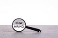 magnifier focuses on the text: NOW HIRING. analyzing for business Royalty Free Stock Photo