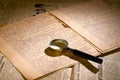 Magnifier glass on page of ancient manuscript