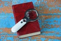 Magnifier lies on a red book on  table Royalty Free Stock Photo