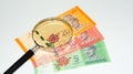 Magnifier with Malaysia bank notes.concept photo.