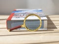 Magnifier near thick technical book for education. Concept of scientific knoledge and study Royalty Free Stock Photo