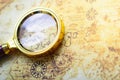 Magnifier on old map background. Royalty Free Stock Photo