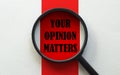 Magnifier with text Your Opinion Matters on the white and red background