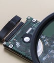 Magnifing glass is enlarging specific areas on a integrated circuit oard fused in  computers Royalty Free Stock Photo