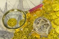 Magnify glass compass on a golden pirate coin Royalty Free Stock Photo