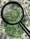 Magnify glass and fingerprint US currency Royalty Free Stock Photo