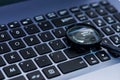 Magnifyer glass on laptop computer keyboard in blue tone, Royalty Free Stock Photo