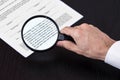 Magnifying class examining footnotes Royalty Free Stock Photo