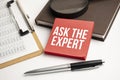 Magnifying Glass with Ask the Expert on the paper sheet and pen Royalty Free Stock Photo