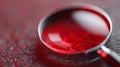 A magnifying glass with blood under it on a table Royalty Free Stock Photo