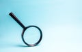 Magnifying glass on blue background. Concept of search and analysis, analytics and study of details. Validation, identification Royalty Free Stock Photo