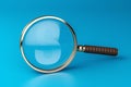 Magnifying glass on blue background SEO search engine optimization concept Royalty Free Stock Photo