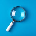 Magnifying glass on blue background SEO search engine optimization concept Royalty Free Stock Photo