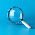 Magnifying glass on blue background SEO search engine optimization concept Royalty Free Stock Photo