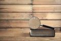 Magnifying glass with book on wooden table. Search and discover Royalty Free Stock Photo