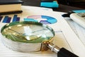 Magnifying glass on business documents. Accounting and financial audit. Royalty Free Stock Photo