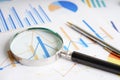 Magnifying glass on charts graphs paper. Financial development, Banking Account, Statistics, Investment Analytic research data Royalty Free Stock Photo