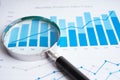 Magnifying glass on charts graphs paper. Financial development, Banking Account, Statistics, Investment Analytic research data Royalty Free Stock Photo