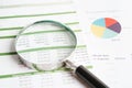 Magnifying glass on charts graphs paper. Financial development, Banking Account, Statistics, Investment Analytic research data Royalty Free Stock Photo