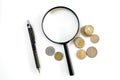 Magnifying glass, coins of various countries