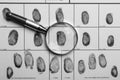 Magnifying glass and criminal fingerprint card