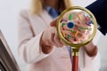 Magnifying glass detecting microbes and business partners shaking hands, closeup