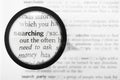 Magnifying glass and dictionary definition of the word searching Royalty Free Stock Photo
