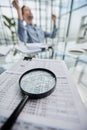 Photo magnifier with graphs and figures in the tables Royalty Free Stock Photo