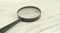 Magnifying glass examining cursive script document detail Royalty Free Stock Photo