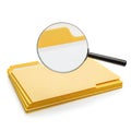 A magnifying glass examining a stack of yellow manila folders Royalty Free Stock Photo