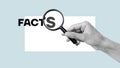 Magnifying glass and facts showing using the text. Checking facts and data concept Royalty Free Stock Photo